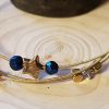 Multi layer guitar string bangle with gold and blue beads