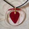 Gold necklace pendant wrapped with red wire with red guitar plectrum